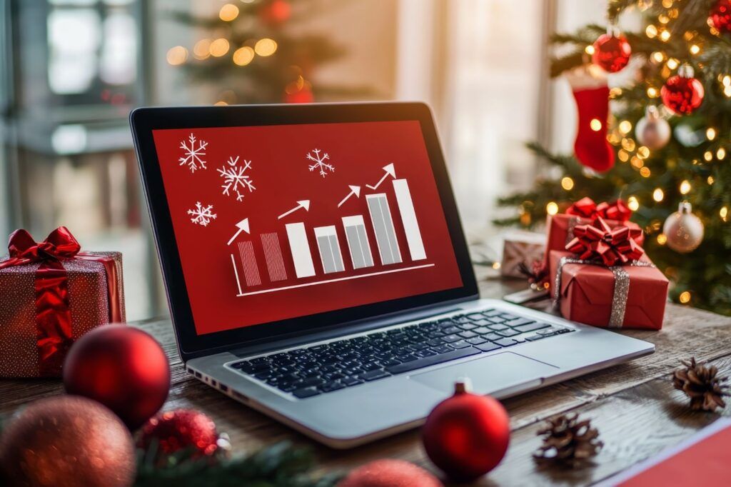 Laptop displaying a bar chart with festive Christmas decorations and gifts around it.