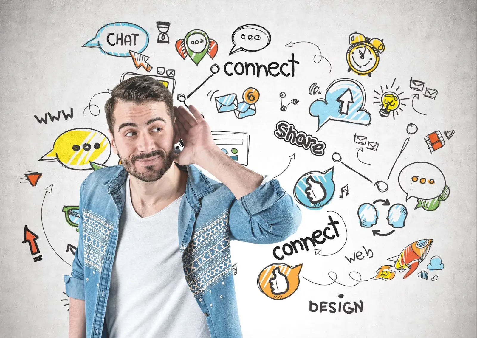 A man in a denim shirt holding his hand to his ear with colorful doodles of social media icons and words like 