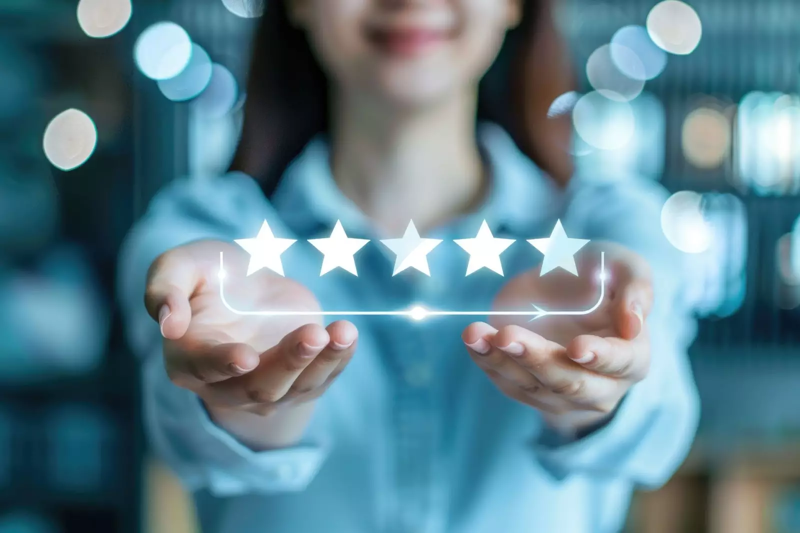 A person in a blue shirt holding out their hands, displaying five glowing star ratings against a blurred background with bokeh lights.