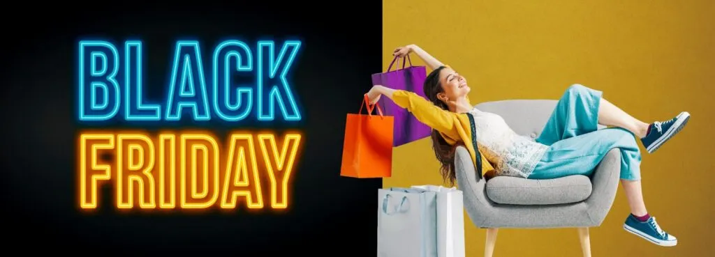 Woman relaxing on a chair with shopping bags, next to BLACK FRIDAY neon sign.